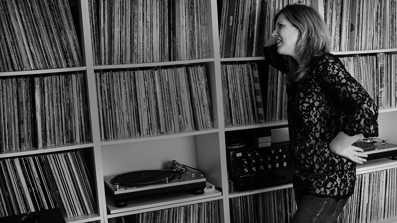 Colleen 'Cosmo' Murphy browsing her vinyl collection beside a turntable and mixer